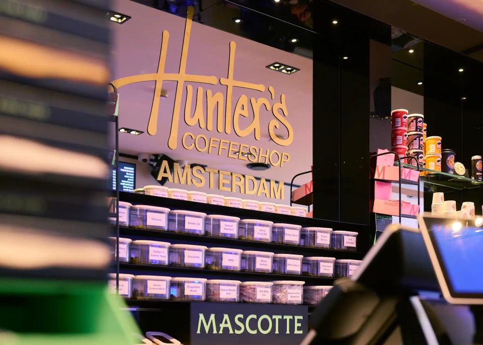 Hunter's coffeeshop product wall and Amsterdam branding