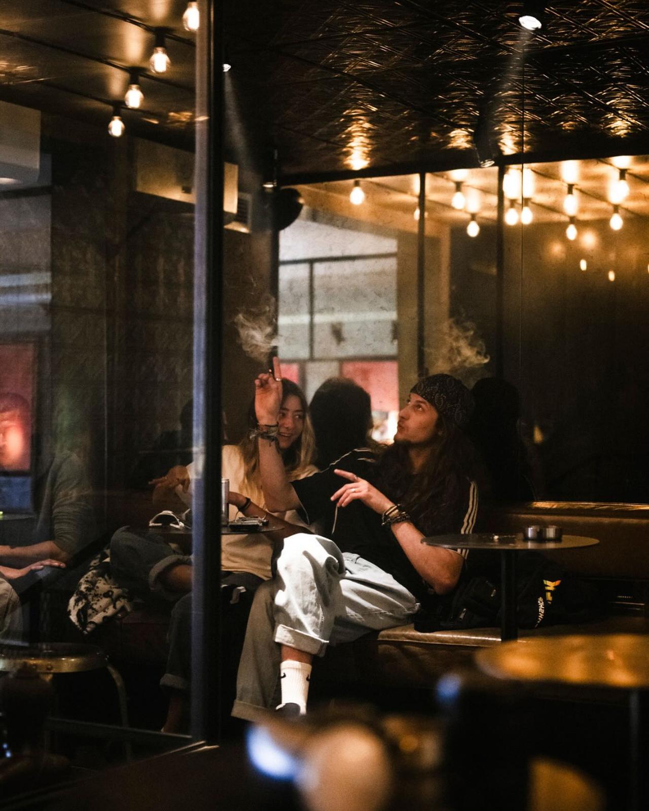 Guests smoking and socialising inside a Kadinsky venue