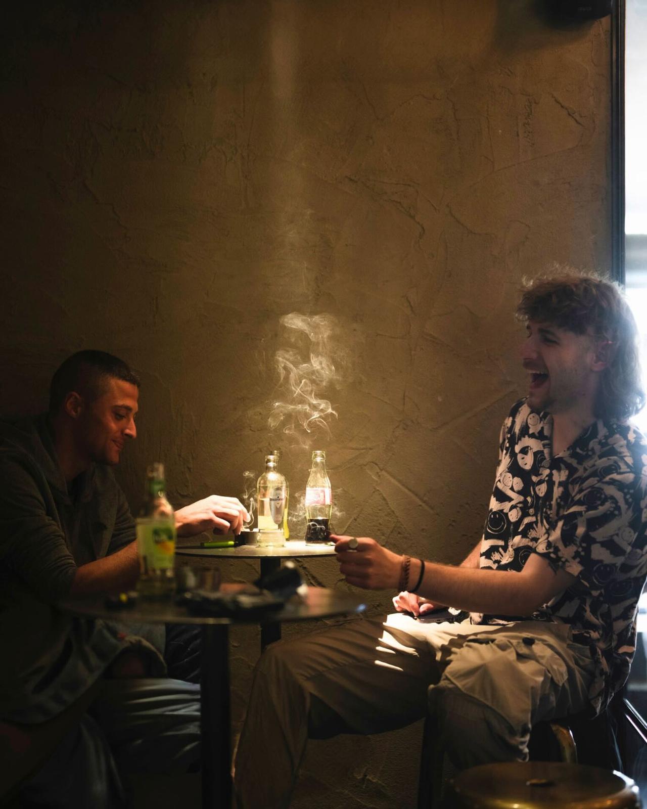 Guests smoking together inside Kadinsky